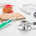 Syringe, bandaid and stethoscope