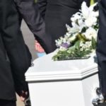 White casket being carried