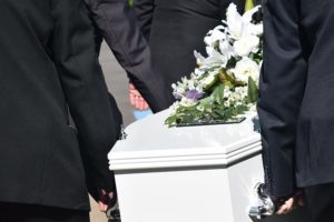 White casket being carried