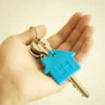 Person holding home keys