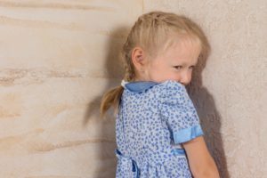 Little girl standing in corner