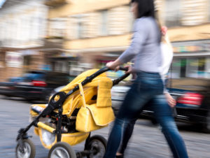 Woman pushing child in stroller