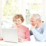 Senior couple using laptop