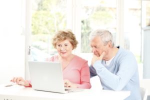 Senior couple using laptop