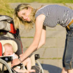 Woman with baby on stroller