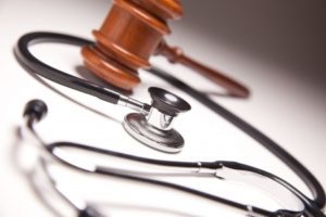 Gavel and stethoscope on table