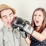 Woman punching man in the face