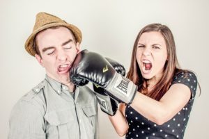 Woman punching man in the face