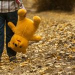 Child holding teddy bear