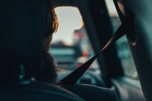 Woman in passenger seat wearing seatbet