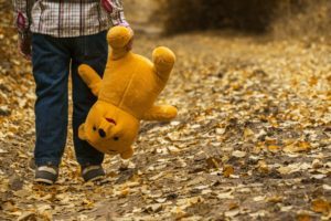 Child holding teddy bear