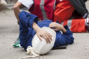 Injured construction worker laying on ground