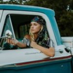 Young woman driving pickup truck
