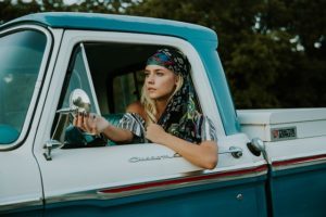 Young woman driving pickup truck