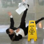 Business man slips on wet floor