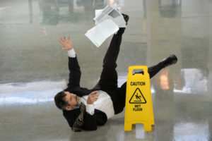 Business man slips on wet floor