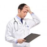 Stressed doctor holding chart