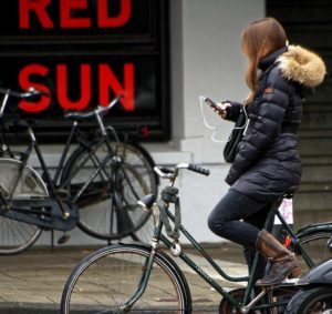 Girl biking and texting