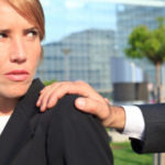 Man holding woman's shoulder