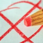 Red pencil with an X