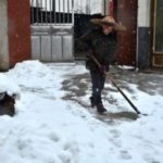 Woman shoveling snow