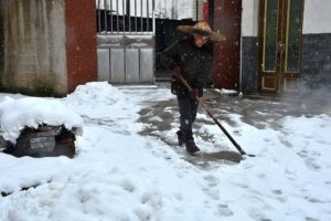 Woman shoveling snow