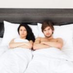 Upset young couple in bed