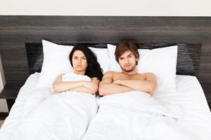 Upset young couple in bed