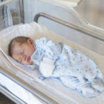Newborn boy in crib
