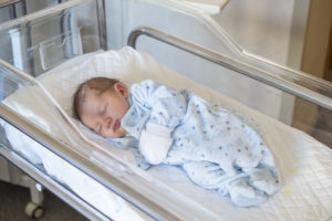 Newborn boy in crib, medic