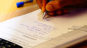 Person signing their name