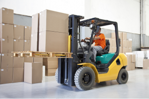 Worker is using lifter to carry packages