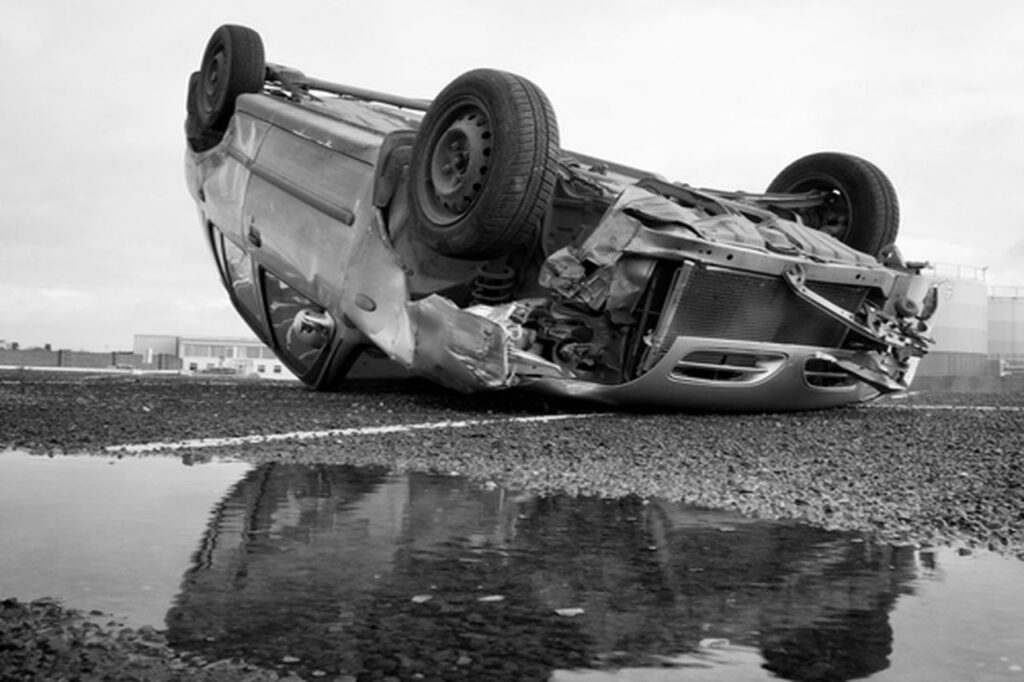 Rolled over car crash, poor pothole